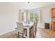 Cozy dining area with a wooden table and chairs, with plenty of natural light streaming in at 105 Oakfield Way, Douglasville, GA 30134
