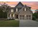 Charming two-story home with brick and siding, a welcoming porch, and a two-car garage at 105 Oakfield Way, Douglasville, GA 30134