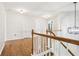 Upstairs hallway area featuring hardwood flooring, lighting, and access to other rooms at 105 Oakfield Way, Douglasville, GA 30134