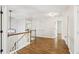 Upstairs hallway featuring hardwood flooring, lighting, and access to other rooms at 105 Oakfield Way, Douglasville, GA 30134