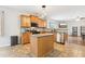 Modern kitchen with stainless steel appliances, an island, and an open view to the living room at 105 Oakfield Way, Douglasville, GA 30134