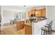 An eat-in kitchen features wood cabinets, stainless appliances, and stone countertops at 105 Oakfield Way, Douglasville, GA 30134