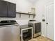 Laundry room with new stainless steel washer and dryer at 105 Oakfield Way, Douglasville, GA 30134