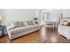 Bright living room featuring a comfortable sofa, hardwood floors, and a dining area at 105 Oakfield Way, Douglasville, GA 30134
