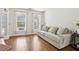 Inviting living room with hardwood floors, bright windows, and a comfortable sofa at 105 Oakfield Way, Douglasville, GA 30134