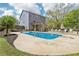Backyard features a sparkling pool, wooden deck with lounge chairs, and lush landscaping at 105 Oakfield Way, Douglasville, GA 30134