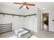 Walk-in closet featuring shelving, lighting, storage ottoman, and a ceiling fan at 105 Oakfield Way, Douglasville, GA 30134