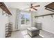 Spacious walk-in closet with shelves, storage ottoman, window, and ceiling fan at 105 Oakfield Way, Douglasville, GA 30134