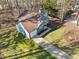 This aerial view shows a well-maintained single Gathering home with a large driveway, and attached garage at 109 Beaver Dam Rd, Peachtree City, GA 30269