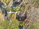 Aerial view of a home with a brown roof, green lawns, and mature trees at 109 Beaver Dam Rd, Peachtree City, GA 30269
