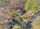 Aerial view of a charming single-Gathering home with a long driveway, lush lawn and a wooded surrounding at 109 Beaver Dam Rd, Peachtree City, GA 30269