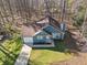 This home has great curb appeal with fresh landscaping, green grass, blue siding and crisp white garage door at 109 Beaver Dam Rd, Peachtree City, GA 30269