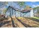 The back side of a blue house with a yard and mature trees at 109 Beaver Dam Rd, Peachtree City, GA 30269