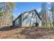 Exterior view of a house with blue siding, dark roof, and mature trees at 109 Beaver Dam Rd, Peachtree City, GA 30269