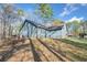 A house on a grassy hill with blue siding and a brown roof at 109 Beaver Dam Rd, Peachtree City, GA 30269