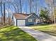 Cozy single-Gathering home with blue siding, attached garage, and well-manicured front yard at 109 Beaver Dam Rd, Peachtree City, GA 30269