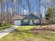 Inviting single-Gathering home with blue siding, attached garage, and well-manicured lawn on a sunny day at 109 Beaver Dam Rd, Peachtree City, GA 30269
