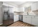 Bright kitchen featuring stainless steel appliances, white cabinets, granite countertops and modern fixtures at 109 Beaver Dam Rd, Peachtree City, GA 30269