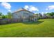 Expansive fenced backyard featuring lush green grass and a covered patio, ideal for outdoor entertaining and relaxation at 3048 Level Grove Ln, Dacula, GA 30019