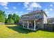 Beautiful backyard with a covered patio, mature trees, and ample space for outdoor activities and relaxation at 3048 Level Grove Ln, Dacula, GA 30019