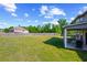 Expansive backyard featuring lush green lawn, privacy fence, and a covered patio area for outdoor enjoyment at 3048 Level Grove Ln, Dacula, GA 30019