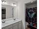 Bathroom featuring double sinks, a framed mirror, and a separate room for the toilet and shower/bath at 3048 Level Grove Ln, Dacula, GA 30019