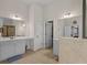 Well-lit bathroom with double vanity, glass shower, and tile flooring at 3048 Level Grove Ln, Dacula, GA 30019