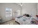 Cozy bedroom with neutral walls, carpeted floors, and two bright windows for natural light at 3048 Level Grove Ln, Dacula, GA 30019