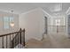 Well-lit hallway featuring carpet, chandelier lighting, and access to multiple rooms at 3048 Level Grove Ln, Dacula, GA 30019