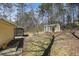A storage shed, screened porch, and mature trees adorn the beautiful backyard at 4186 Argonne Dr, Villa Rica, GA 30180