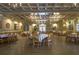 Spacious ballroom with hardwood floors, elegant chandeliers, and tables set for a dining event at 4186 Argonne Dr, Villa Rica, GA 30180