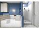 Spacious bathroom features a tub, a shower, white cabinets and blue walls at 4186 Argonne Dr, Villa Rica, GA 30180