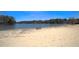 Sandy beach area with picnic tables, volleyball net and lake views in a lakeside community at 4186 Argonne Dr, Villa Rica, GA 30180