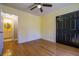 Bedroom boasts hardwood floors, a ceiling fan and access to an adjoining bathroom at 4186 Argonne Dr, Villa Rica, GA 30180
