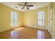 Sunlit bedroom features hardwood floors, two windows, a ceiling fan and a side door at 4186 Argonne Dr, Villa Rica, GA 30180