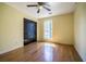 Bedroom features hardwood floors, closet doors, a ceiling fan and a bright window at 4186 Argonne Dr, Villa Rica, GA 30180