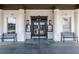 Elegant clubhouse entrance with columns, benches, and glass doors, welcoming visitors at 4186 Argonne Dr, Villa Rica, GA 30180