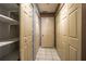 Hallway with tiled floor and multiple storage closets and shelving at 4186 Argonne Dr, Villa Rica, GA 30180