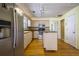 Kitchen with stainless steel appliances, an island, light wood cabinets, and hardwood floors at 4186 Argonne Dr, Villa Rica, GA 30180
