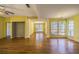 Open-concept living room with wood floors, yellow walls, and lots of natural light from bright windows at 4186 Argonne Dr, Villa Rica, GA 30180