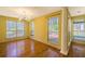 Bright living room featuring wood floors, columns, yellow walls, and large windows with views at 4186 Argonne Dr, Villa Rica, GA 30180