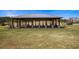 Outdoor pavilion with a metal roof, stone columns and dining space surrounded by a large lawn at 4186 Argonne Dr, Villa Rica, GA 30180