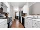 Modern kitchen design with white cabinets and stainless steel appliances, open to dining area at 1731 Pryor Sw Rd # 108, Atlanta, GA 30315