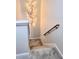 Carpeted stairs with wooden handrail and decorative light fixture on the wall at 1731 Pryor Sw Rd # 108, Atlanta, GA 30315