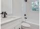 Updated bathroom with a tub and shower combination, white subway tiles, and modern fixtures at 1861 Dyer Cir, Atlanta, GA 30341