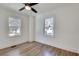 A bright, minimal bedroom with hardwood floors, two windows and a ceiling fan at 1861 Dyer Cir, Atlanta, GA 30341