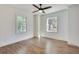 Spacious bedroom with hardwood floors, ceiling fan, and plenty of natural light from two windows at 1861 Dyer Cir, Atlanta, GA 30341