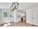 Bright dining area showcasing an elegant light fixture, hardwood floors, and access to the kitchen with stainless steel appliances at 1861 Dyer Cir, Atlanta, GA 30341