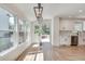 Sun-filled dining area featuring hardwood floors, large windows, a modern light fixture, and access to the all-white kitchen at 1861 Dyer Cir, Atlanta, GA 30341