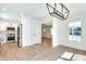 Open dining area featuring hardwood floors and an open transition to the all-white kitchen with stainless steel appliances at 1861 Dyer Cir, Atlanta, GA 30341